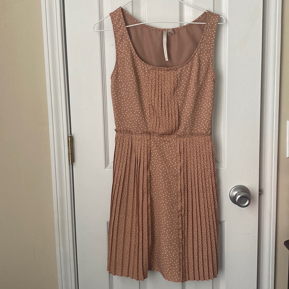 Polka dotted, pleated dress